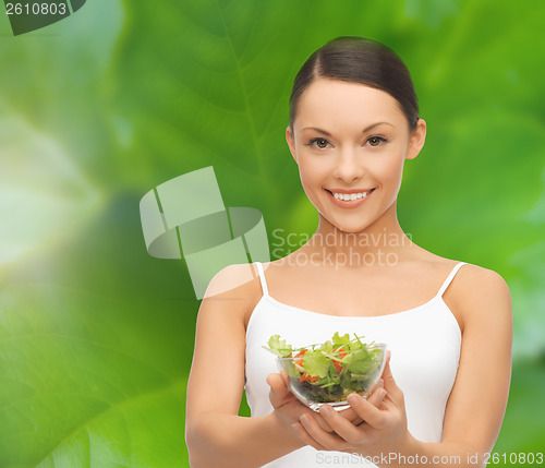 Image of healthy woman holding bowl with salad