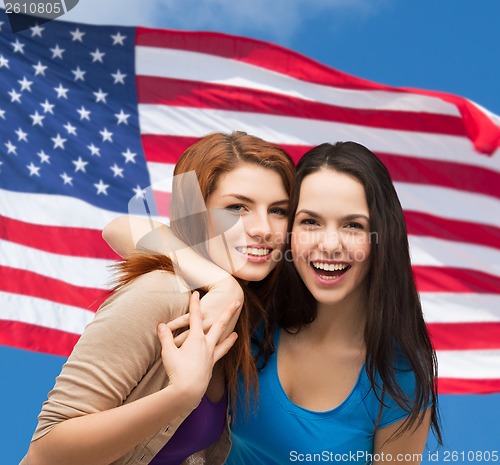 Image of two laughing girls hugging