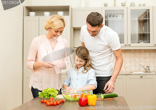 Image of happy family making dinner in kitchen