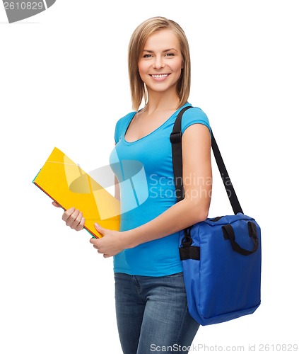 Image of smiling female student with bag and folders