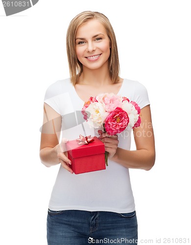 Image of smiling woman with bouquet of flowers and gift box