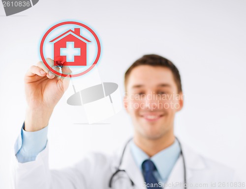 Image of doctor drawing hospital sign in the air