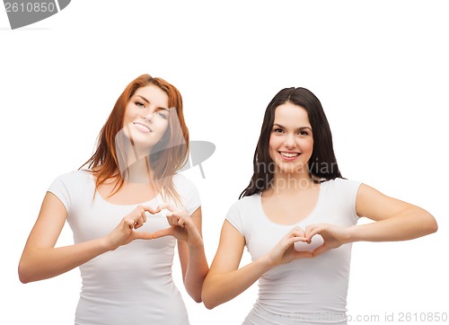 Image of two smiling girls showing heart with hands