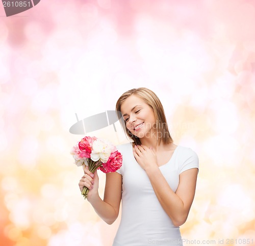 Image of smiling woman with bouquet of flowers