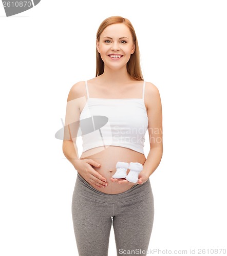 Image of happy future mother holding bootees