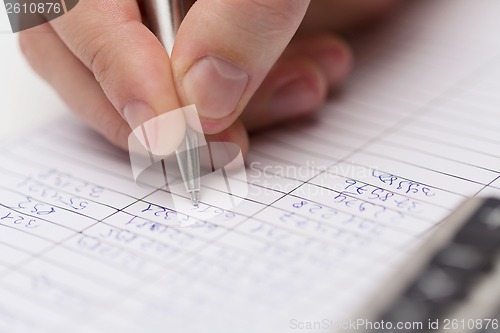 Image of close up of businessman with papers and calculator