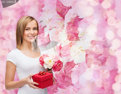 Image of smiling woman with bouquet of flowers and gift box