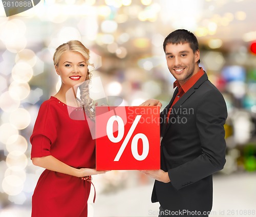 Image of smiling man and woman with percent sign