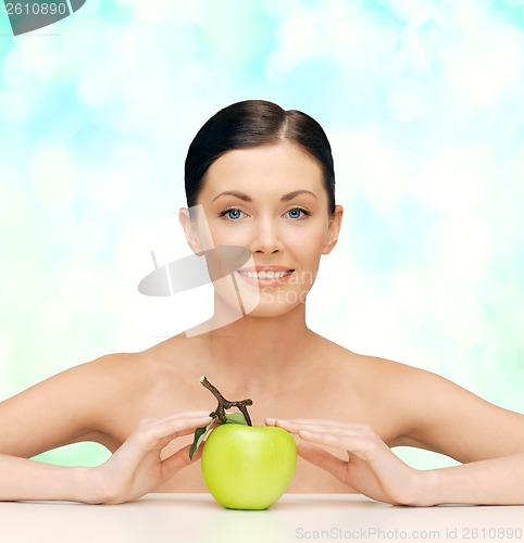 Image of beautiful woman with green apple