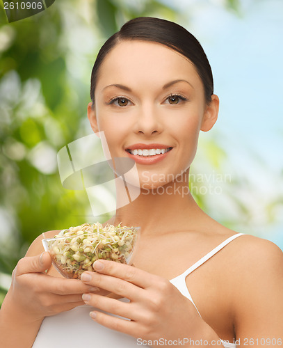 Image of healthy woman holding bowl with sprout