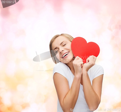 Image of smiling woman in white t-shirt with heart