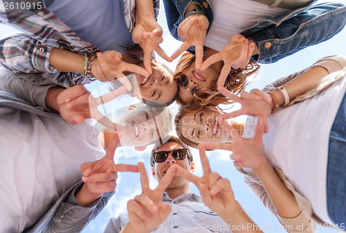 Image of group of teenagers showing finger five