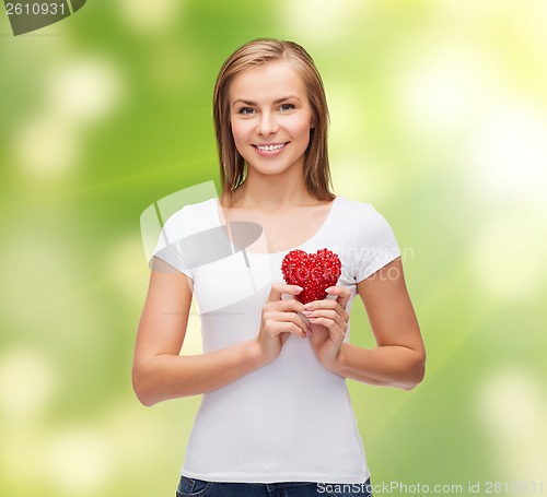 Image of smiling woman in white t-shirt with heart