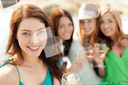 Image of smiling girls with champagne glasses