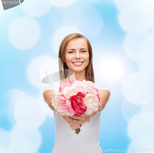 Image of smiling woman with bouquet of flowers