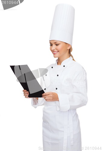 Image of smiling female chef with black blank paper