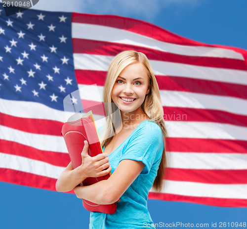 Image of smiling student with folders