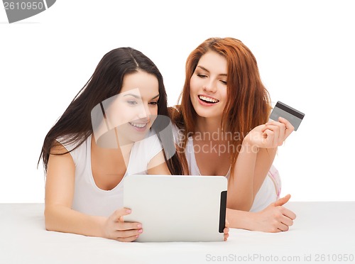 Image of smiling teenagers with tablet pc and credit card