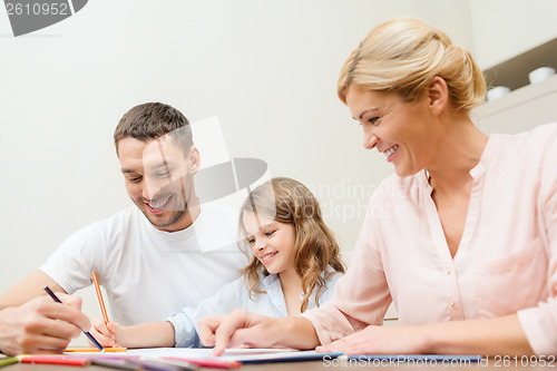 Image of happy family drawing at home