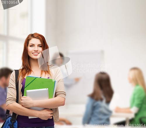 Image of smiling student with bag, folders and tablet pc