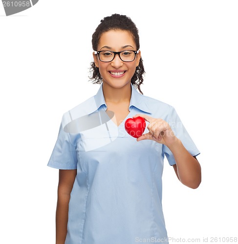 Image of smiling female doctor or nurse with heart