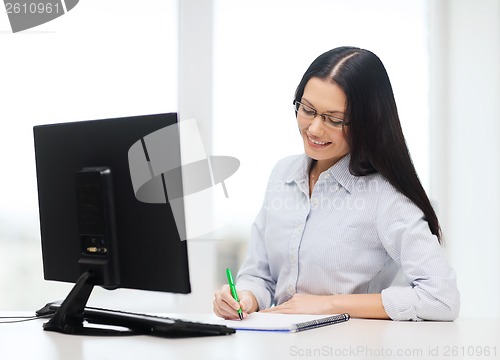 Image of smiling businesswoman or student with eyeglasses