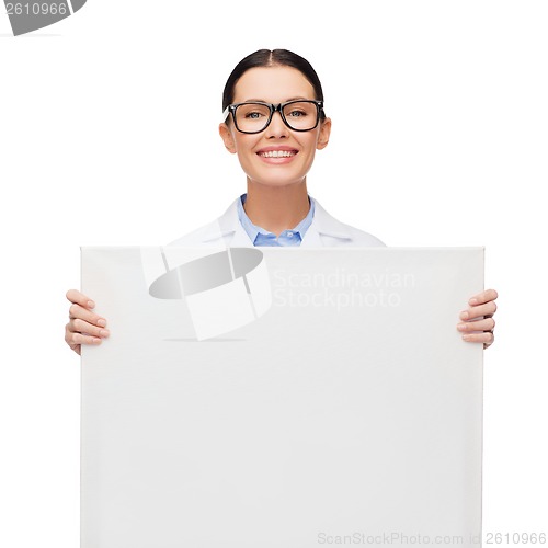 Image of female doctor in eyeglasses with white blank board