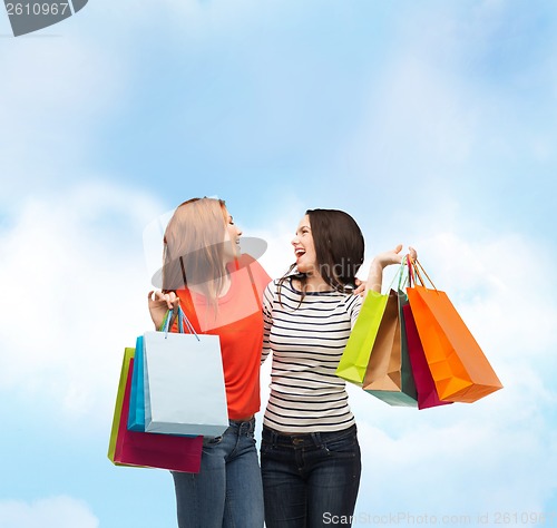 Image of two smiling teenage girls with shopping bags