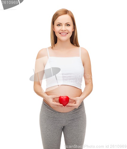 Image of happy future mother holding small red heart