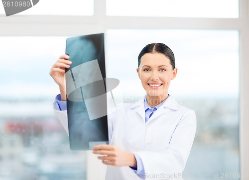 Image of smiling young doctor in cabinet