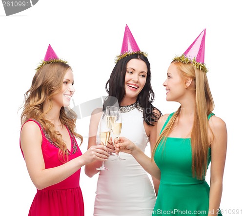 Image of three women in pink hats with champagne glasses