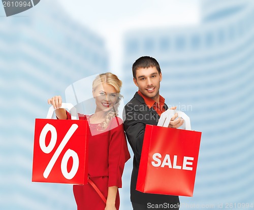 Image of smiling man and woman with shopping bag
