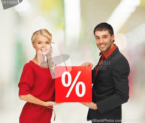 Image of smiling man and woman with percent sign
