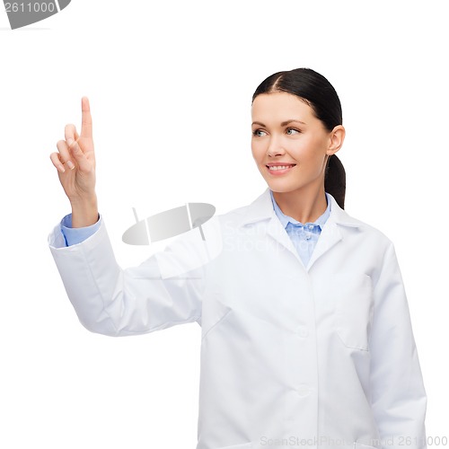 Image of smiling female doctor pointing to something