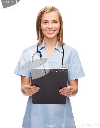 Image of smiling female doctor or nurse with clipboard