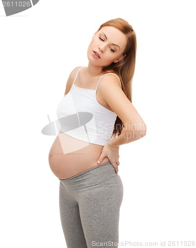 Image of tired future mother supporting her back