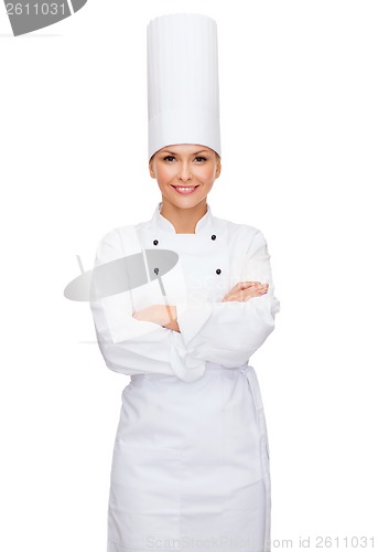 Image of smiling female chef with crossed arms