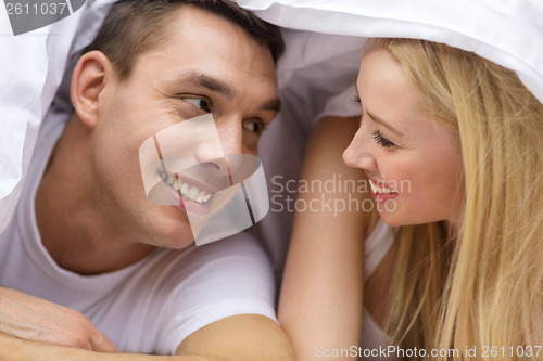 Image of happy couple sleeping in bed