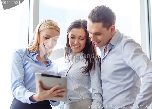 Image of business team working with tablet pc in office
