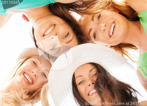 Image of faces of girls looking down and smiling