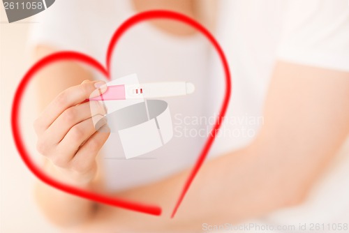 Image of woman and man hands with pregnancy test