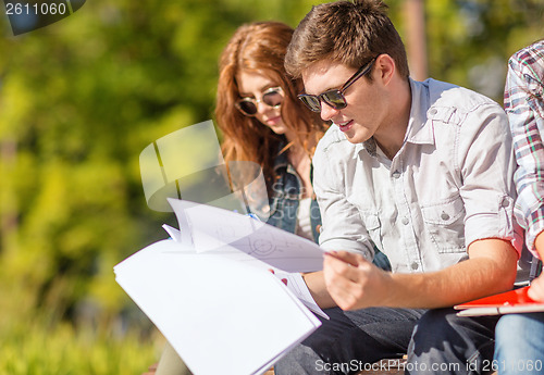 Image of students with books, notebooks, files and folders