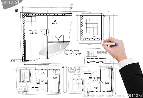 Image of closeup of businessman hand drawing blueprint