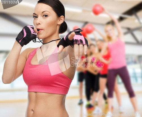 Image of woman with whistle in gym