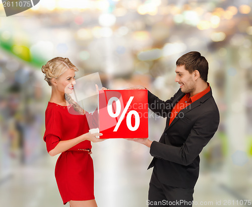 Image of smiling woman and man with red percent sale sign