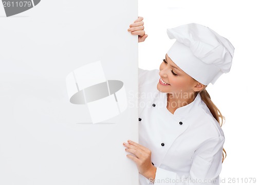 Image of smiling female chef with white blank board