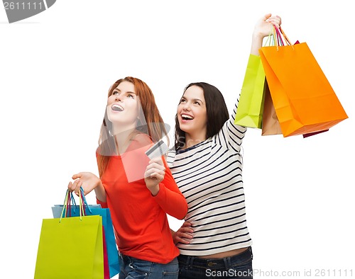 Image of teenage girls with shopping bags and credit card