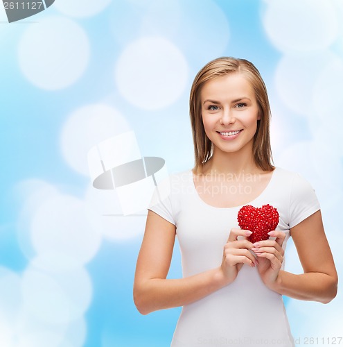 Image of smiling woman in white t-shirt with heart