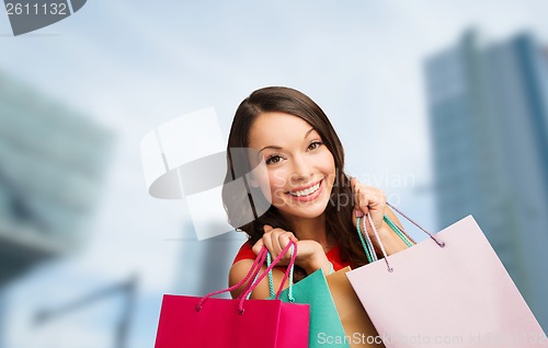 Image of woman in red dress with shopping bags