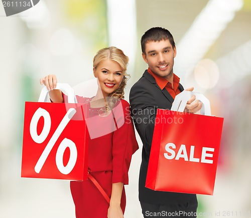 Image of smiling man and woman with shopping bag